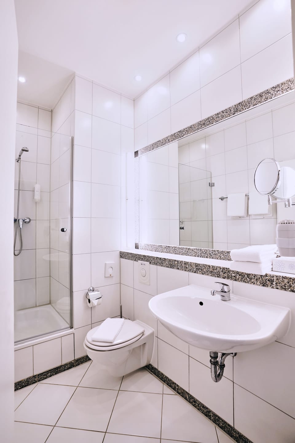 Shower, hair dryer, slippers, towels
