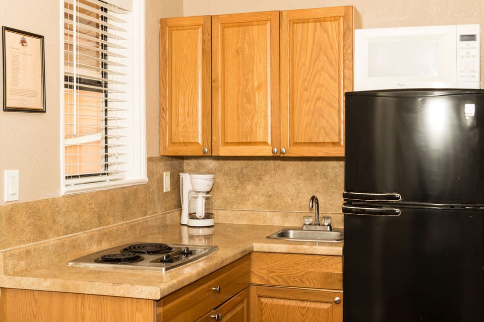 Room, 2 Queen Beds | Private kitchen | Full-size fridge, microwave, stovetop, coffee/tea maker