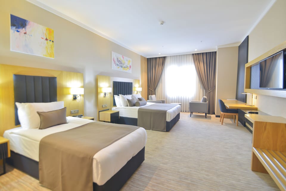 Business Triple Room | Premium bedding, minibar, desk, laptop workspace