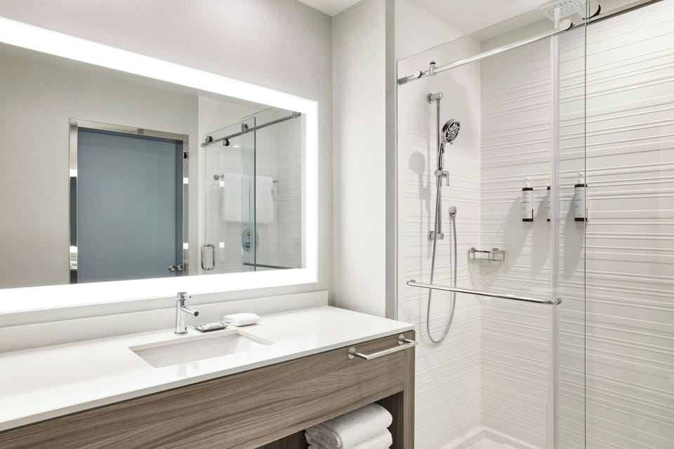 Shower, rainfall showerhead, hair dryer, towels