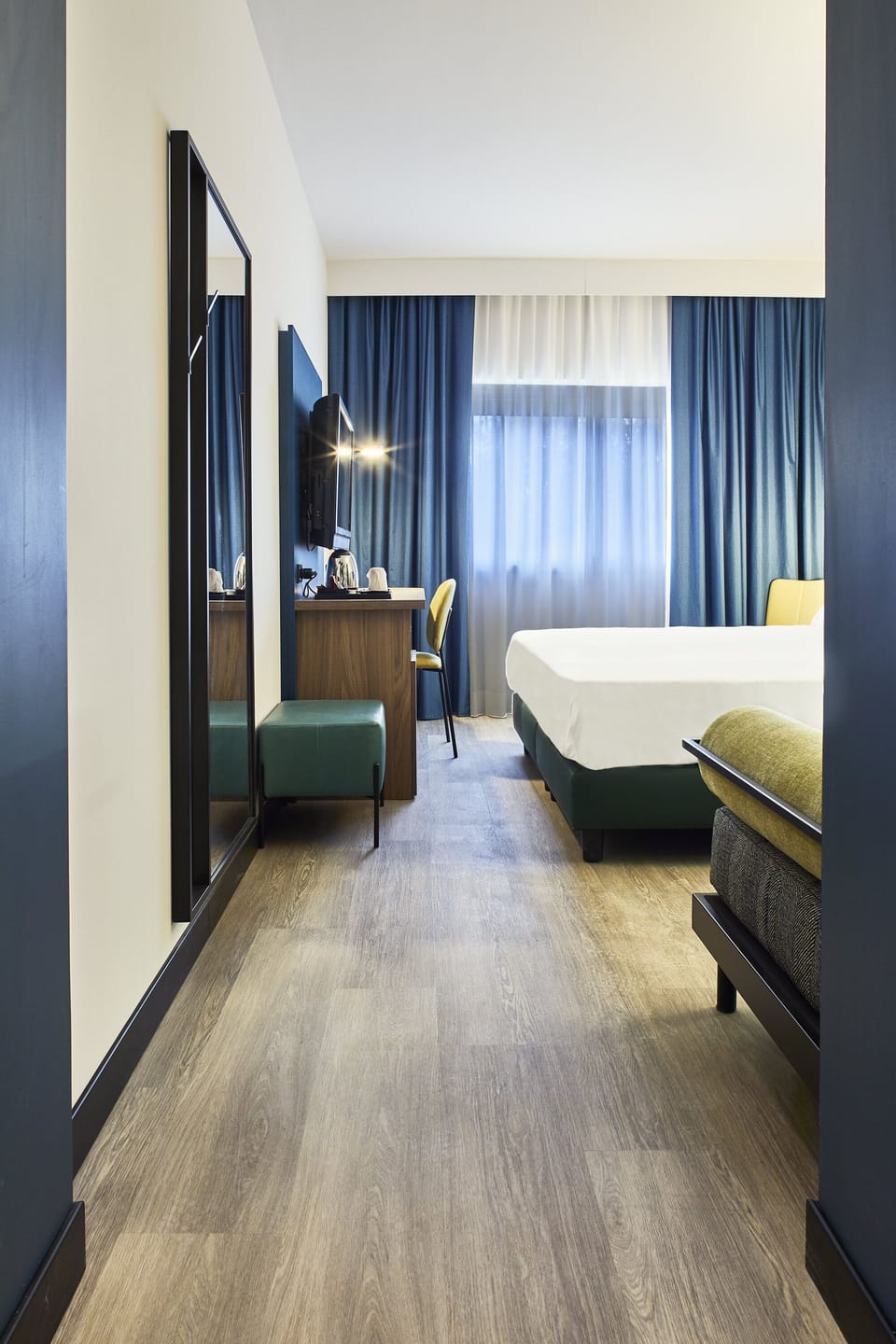 Superior Triple Room | Minibar, desk, laptop workspace, blackout drapes
