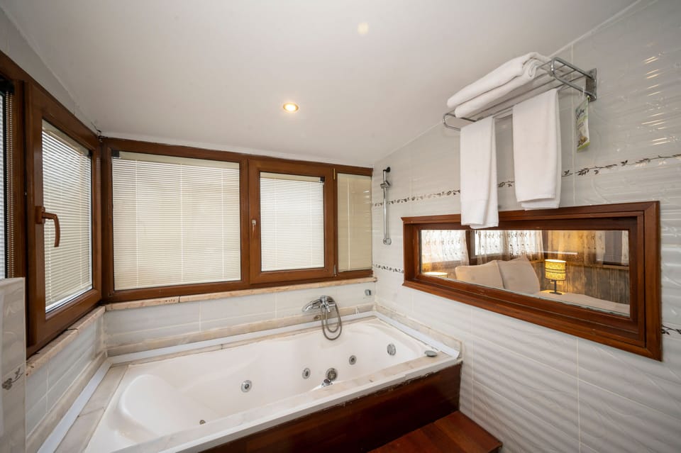 Designer toiletries, hair dryer, slippers, towels