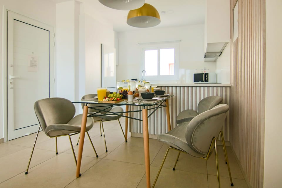 Deluxe Apartment | Private kitchen | Fridge, electric kettle, highchair, dining tables