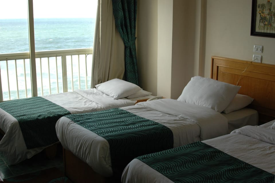 Deluxe Triple Room, Beach View | Minibar, desk, soundproofing, free WiFi
