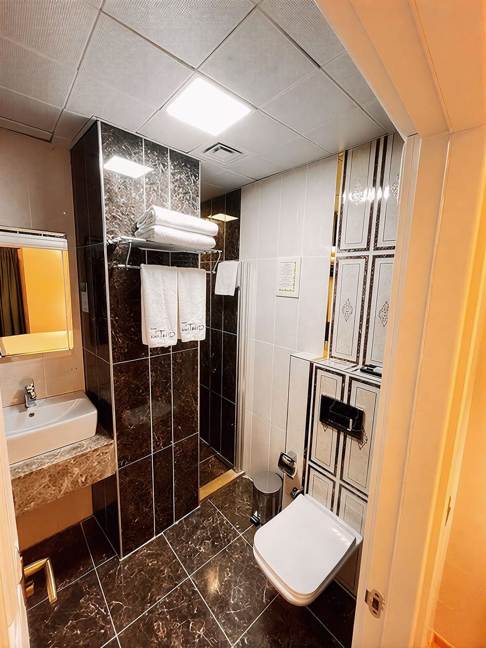 Shower, hair dryer, slippers, towels