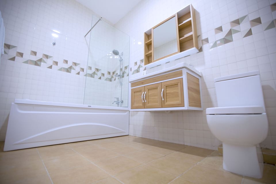 Double Room | Bathroom | Shower, free toiletries, hair dryer (on request), slippers