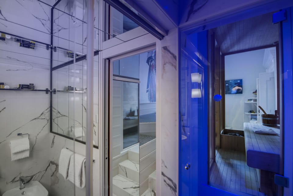 Suite, 1 King Bed | Bathroom | Combined shower/tub, rainfall showerhead, free toiletries, hair dryer