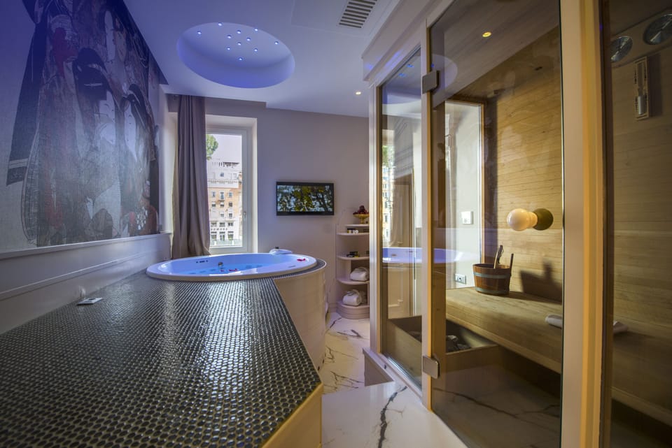 Suite, 1 King Bed | Bathroom | Combined shower/tub, rainfall showerhead, free toiletries, hair dryer