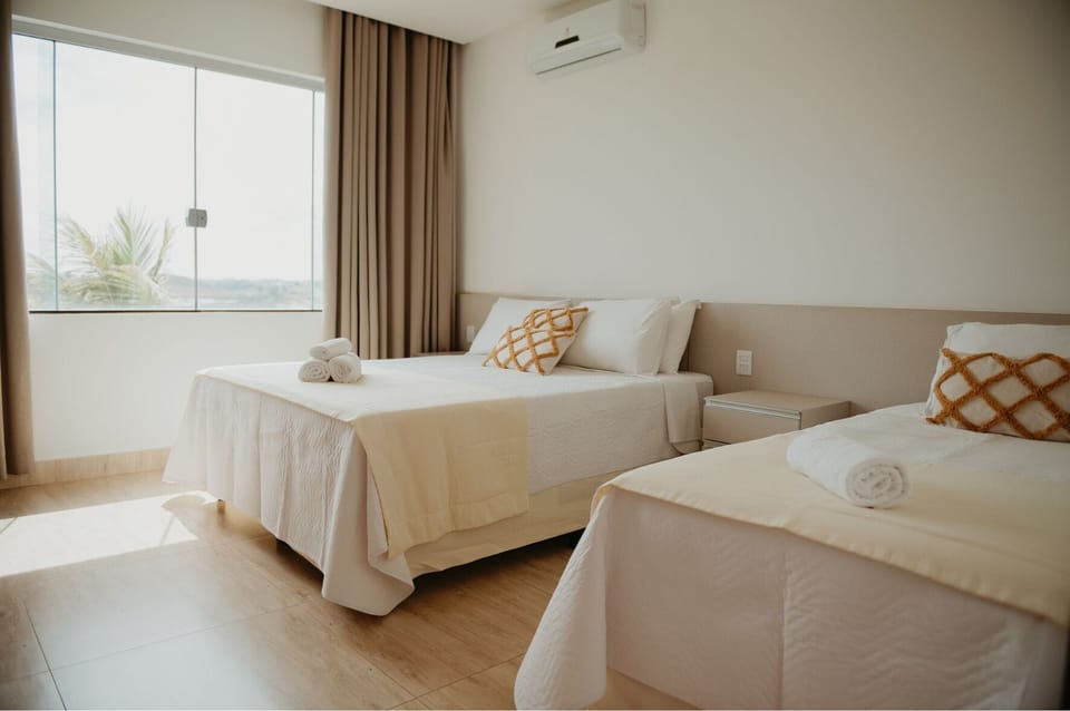 Deluxe Triple Room | Minibar, desk, laptop workspace, blackout drapes
