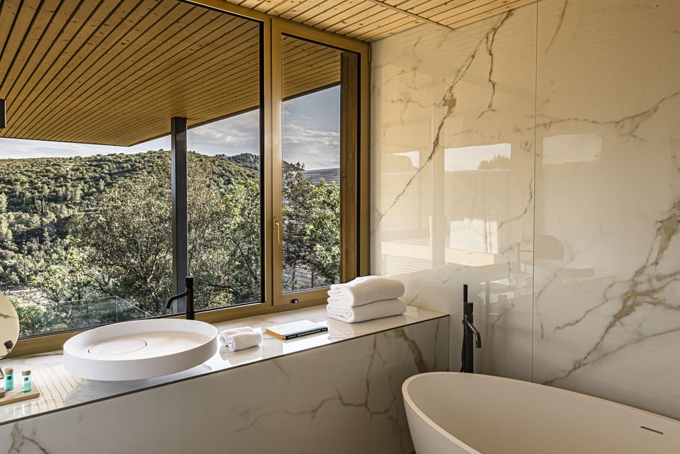 Separate tub and shower, rainfall showerhead, designer toiletries