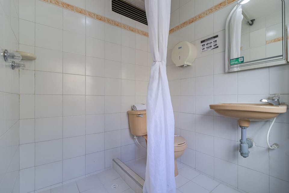 Economy Quadruple Room | Bathroom | Shower, designer toiletries, towels, soap