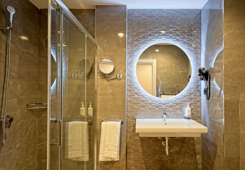 Shower, rainfall showerhead, hair dryer, towels