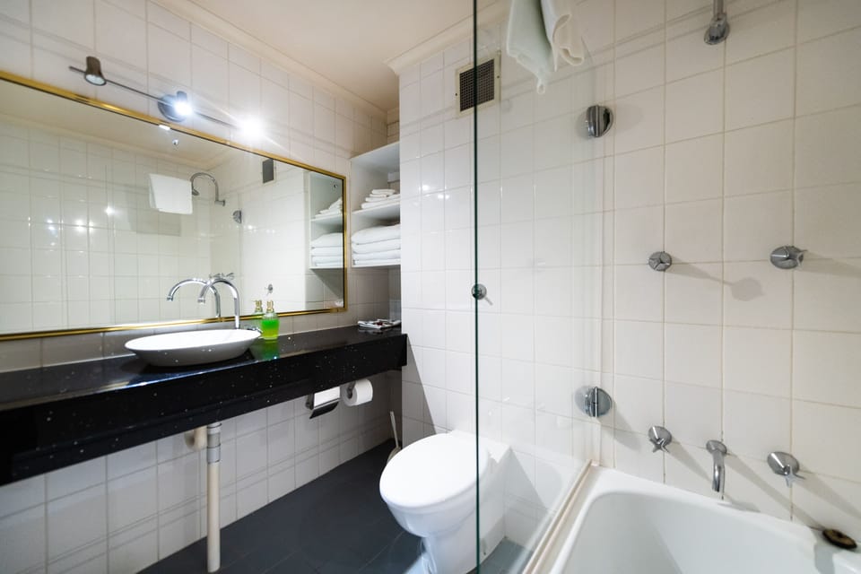Deluxe King Family (4) Room (No Pets) | Bathroom | Eco-friendly toiletries, hair dryer, towels, soap
