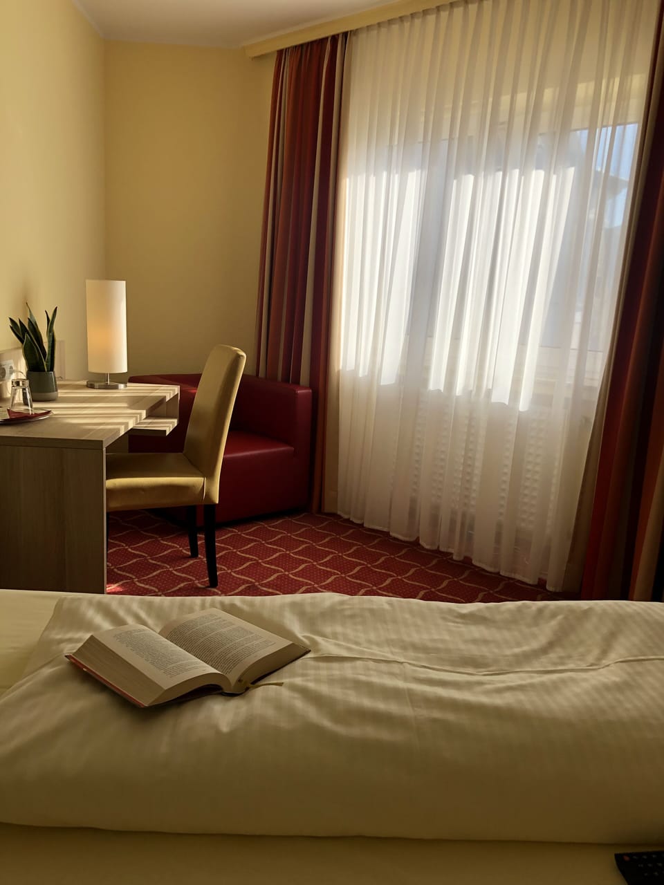 Hypo-allergenic bedding, desk, laptop workspace, blackout drapes