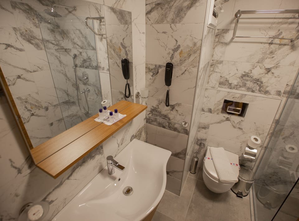 Shower, rainfall showerhead, hair dryer, towels