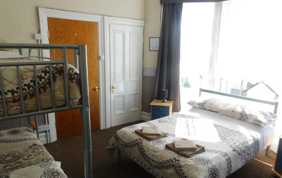 Family Room, Private Bathroom (Private Shower/Shared WC) | Blackout drapes, iron/ironing board, bed sheets