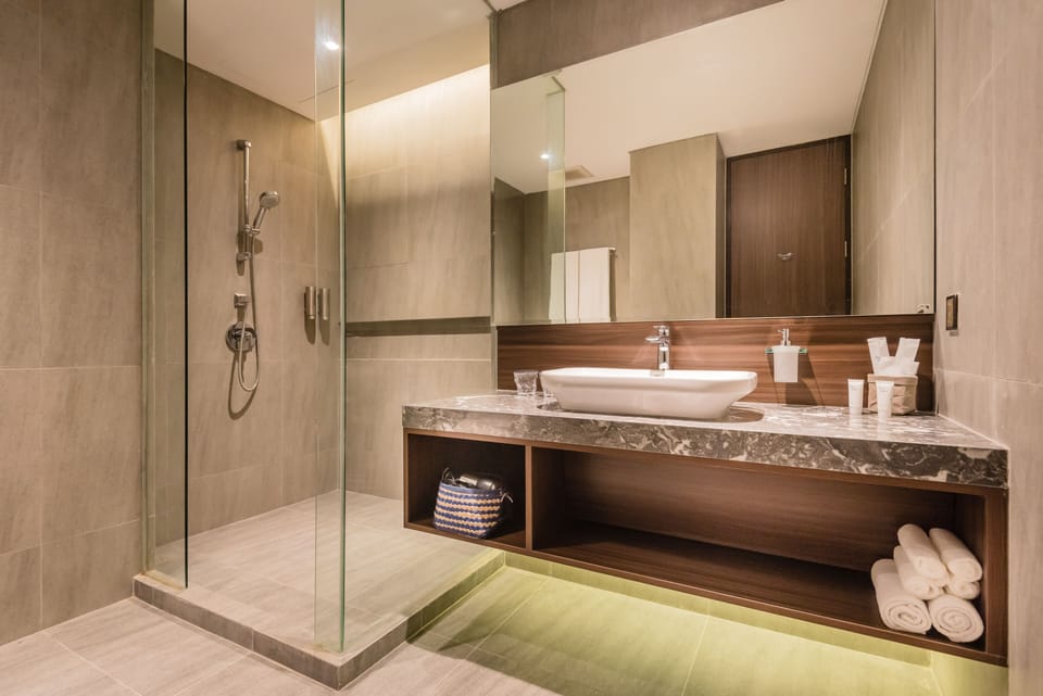 Executive Twin Room (Free Self Service Laundry) | Bathroom | Shower, slippers, towels, soap