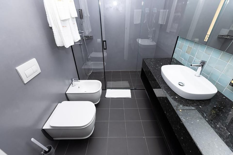 Suite | Bathroom | Hair dryer, slippers, bidet, towels