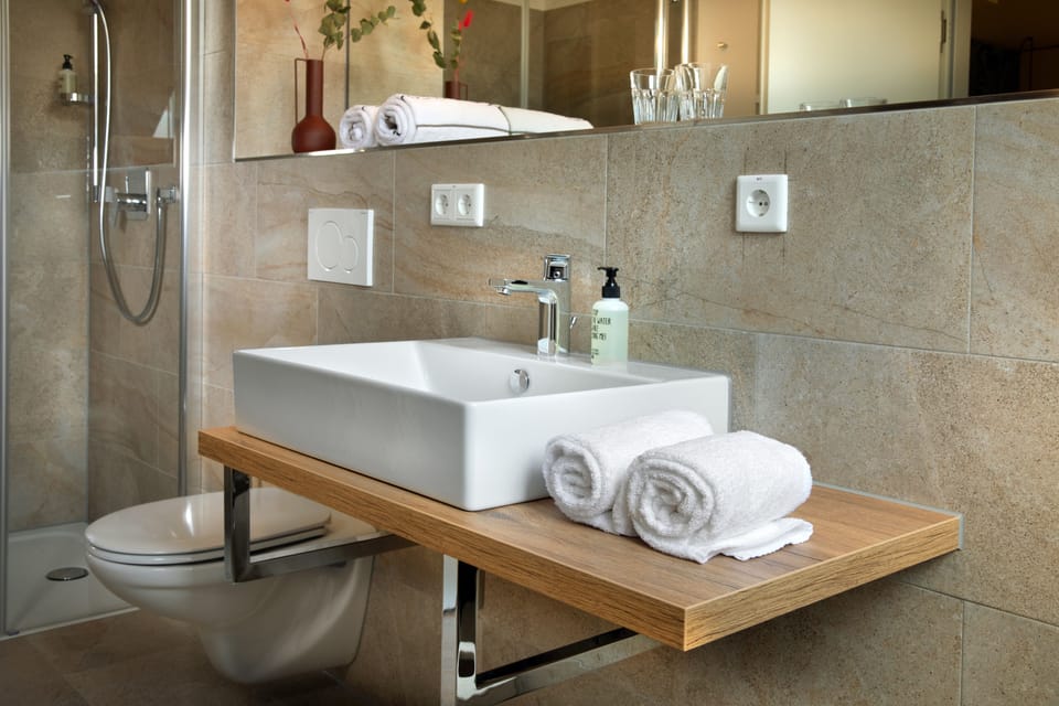 Shower, eco-friendly toiletries, hair dryer, towels
