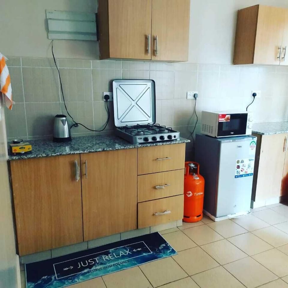 Comfort Apartment | Private kitchen | Fridge, microwave, cookware/dishes/utensils, dining tables