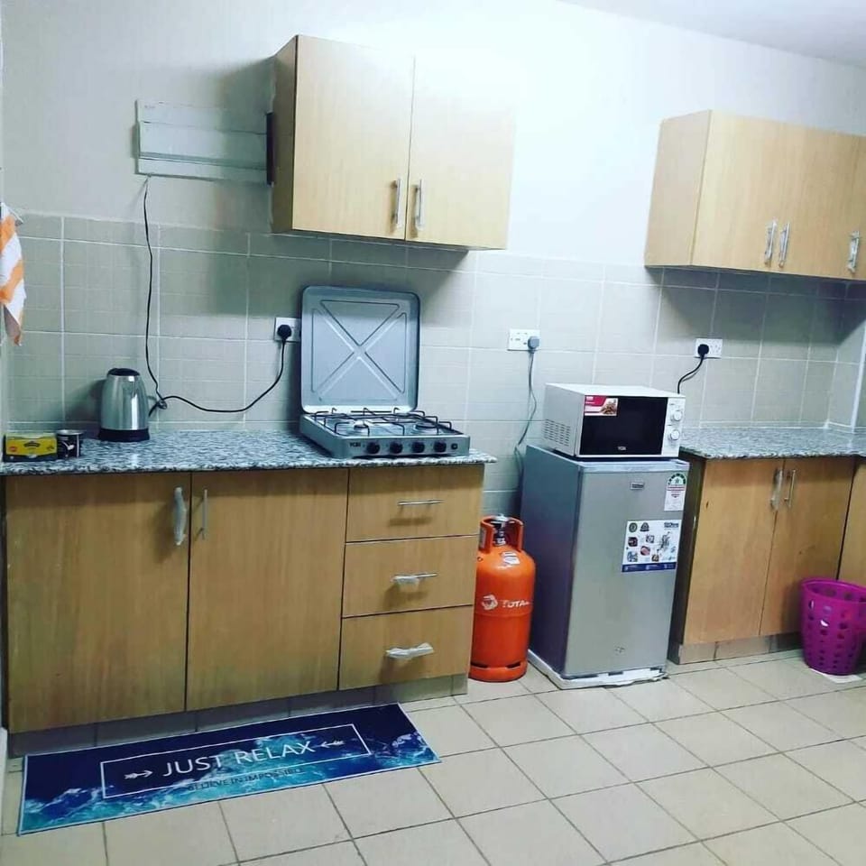 Comfort Apartment | Private kitchen | Fridge, microwave, cookware/dishes/utensils, dining tables