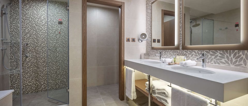 King One Bedroom Suite | Bathroom | Rainfall showerhead, free toiletries, hair dryer, bathrobes