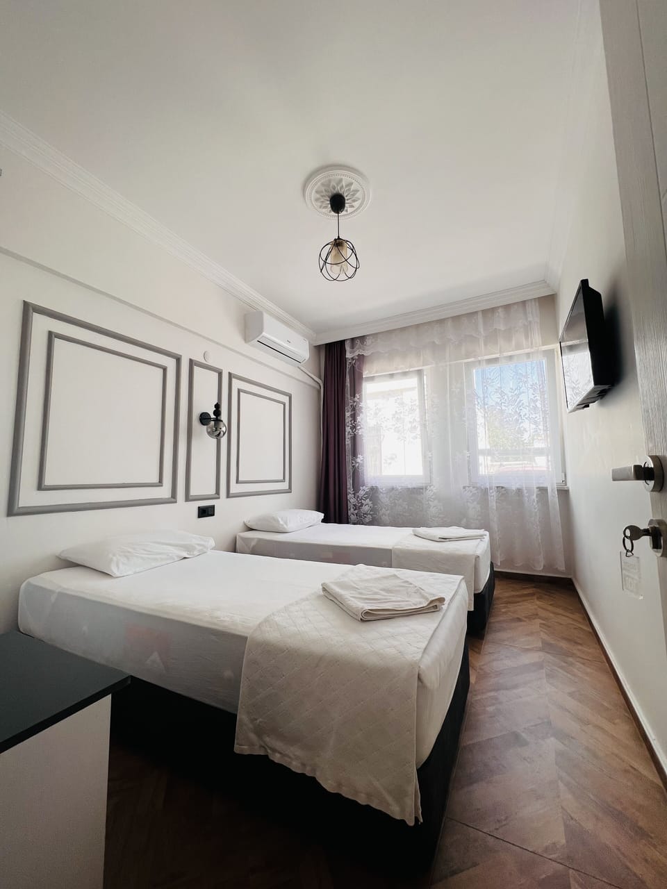Economy Room (private bathroom outside the room) | Minibar, blackout drapes, iron/ironing board, bed sheets
