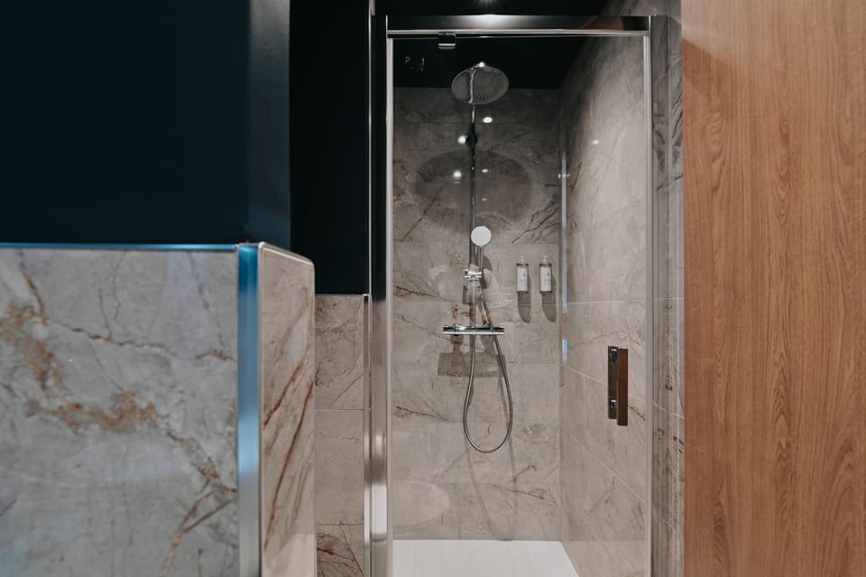 Shower, rainfall showerhead, hair dryer, towels