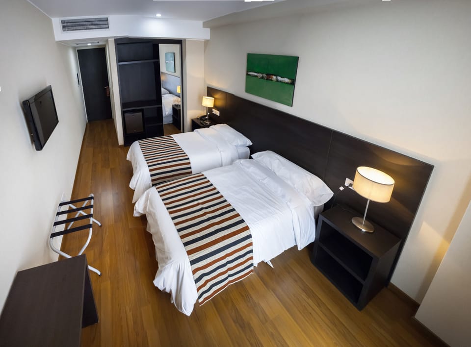 Standard Twin Room | Minibar, in-room safe, desk, soundproofing