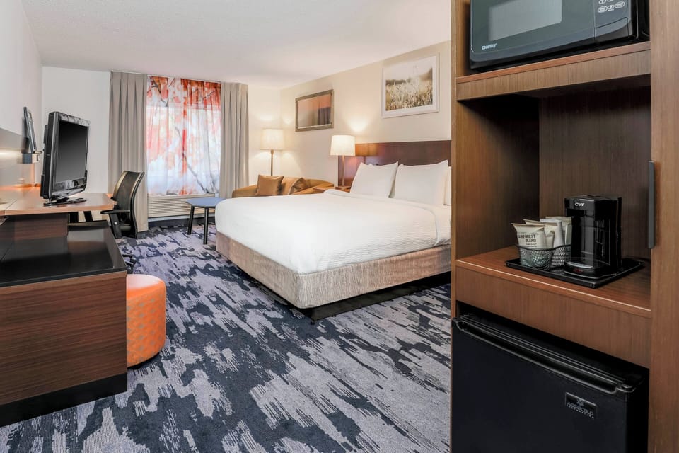 Premium bedding, desk, laptop workspace, blackout drapes