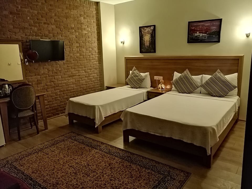Deluxe Triple Room, Non Smoking, Mountain View | Premium bedding, minibar, desk, laptop workspace