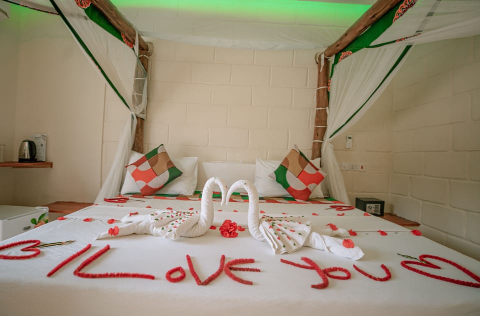 Desk, laptop workspace, iron/ironing board, bed sheets