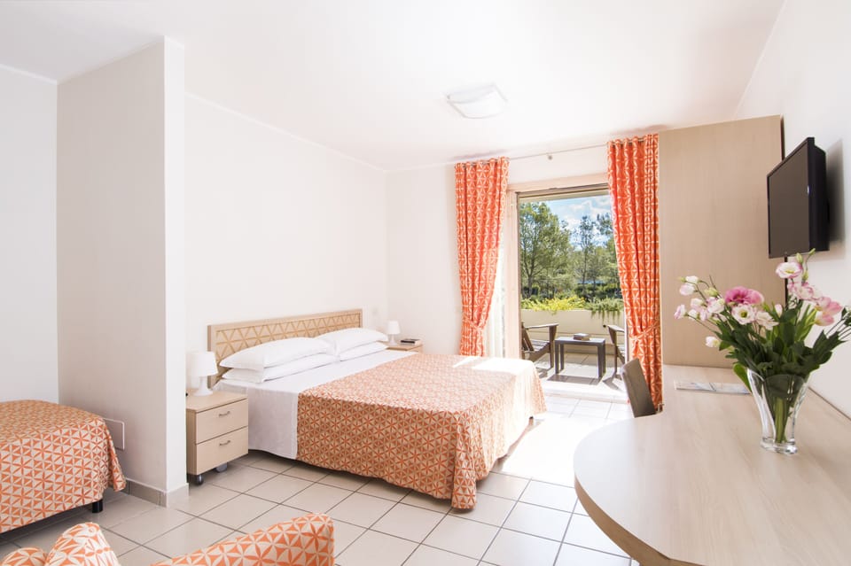 In-room safe, desk, laptop workspace, bed sheets