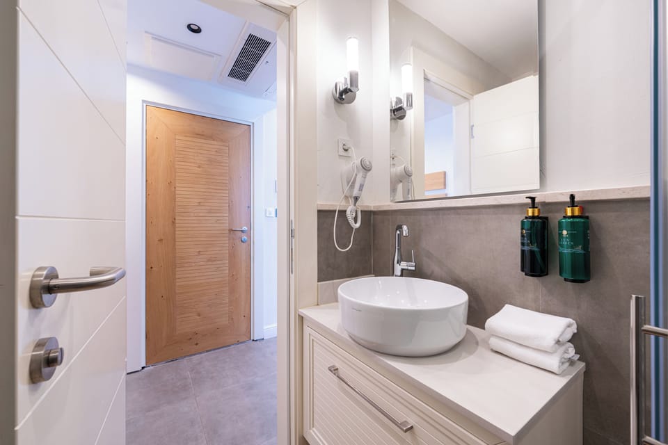 Family Room, 1 Queen Bed with Sofa bed | Bathroom | Shower, rainfall showerhead, hair dryer, bathrobes
