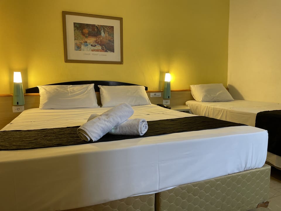 Family Triple Room, Multiple Beds | Blackout drapes, iron/ironing board, free WiFi, bed sheets