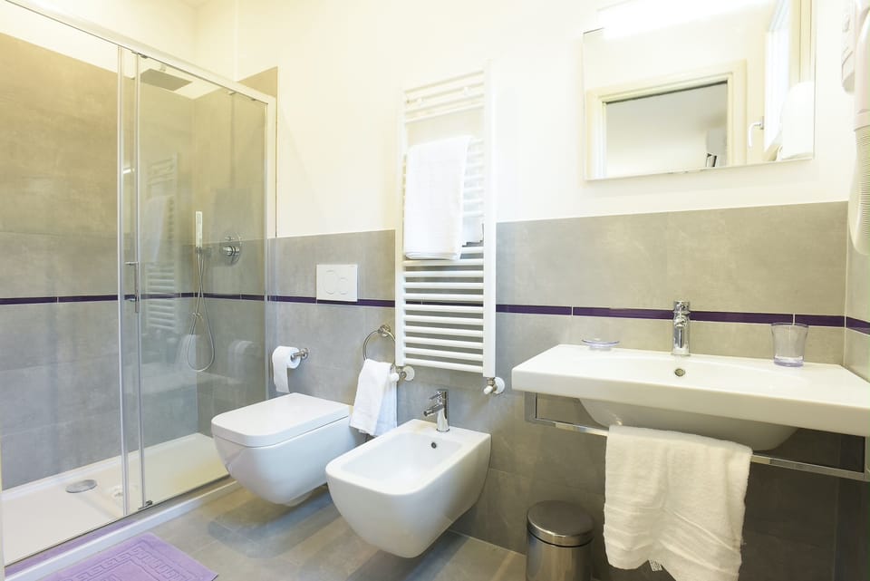 Deluxe Quadruple Room | Bathroom | Hair dryer, bathrobes, bidet, towels