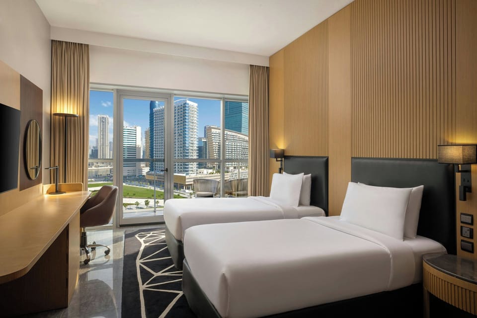 Deluxe Twin Room with Balcony and City View | Down comforters, in-room safe, desk, laptop workspace