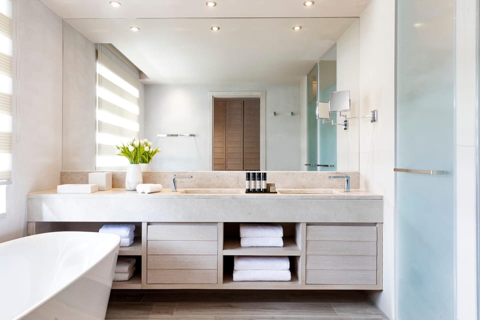 Separate tub and shower, designer toiletries, hair dryer, bathrobes