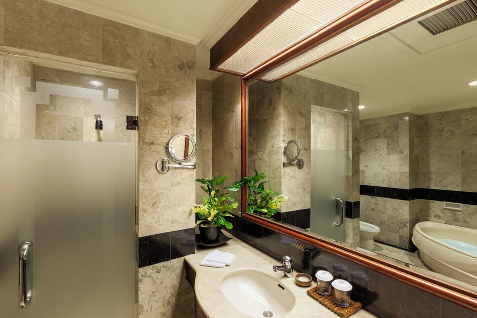 Business Suite | Bathroom | Combined shower/tub, deep soaking tub, free toiletries, bathrobes