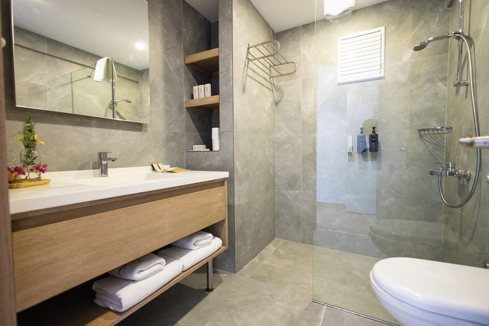 Deluxe Room | Bathroom | Shower, hair dryer, slippers, towels