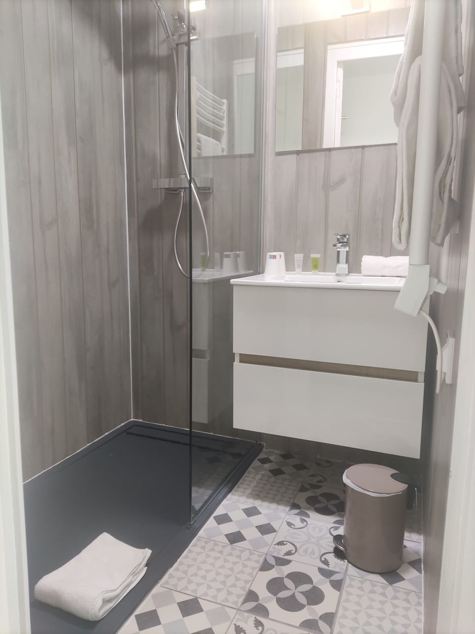 Shower, rainfall showerhead, hair dryer, towels