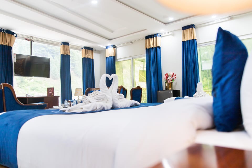Deluxe Quadruple Room | Desk, laptop workspace, WiFi (free), bed sheets