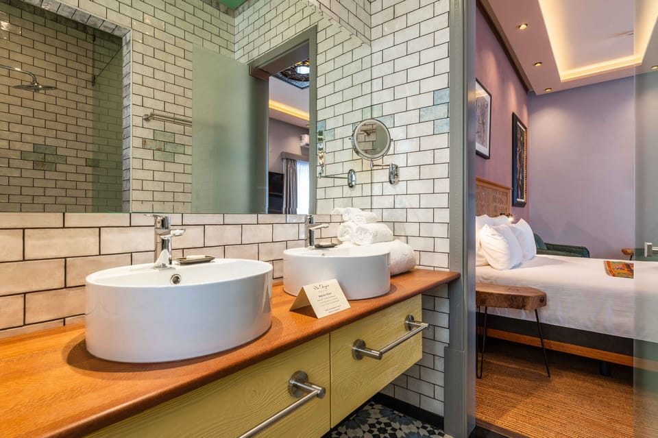 Signature Room | Bathroom | Rainfall showerhead, bathrobes, towels, soap