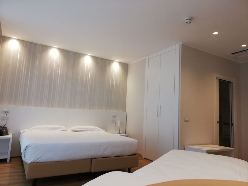 Triple Room | Hypo-allergenic bedding, minibar, desk, blackout drapes