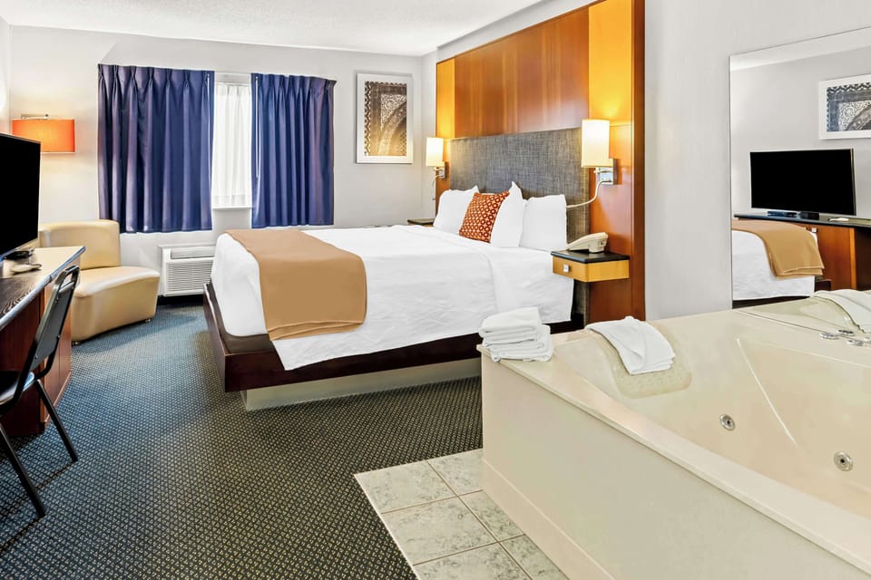 Room, 1 King Bed, Non Smoking, Jetted Tub | In-room safe, desk, blackout drapes, iron/ironing board