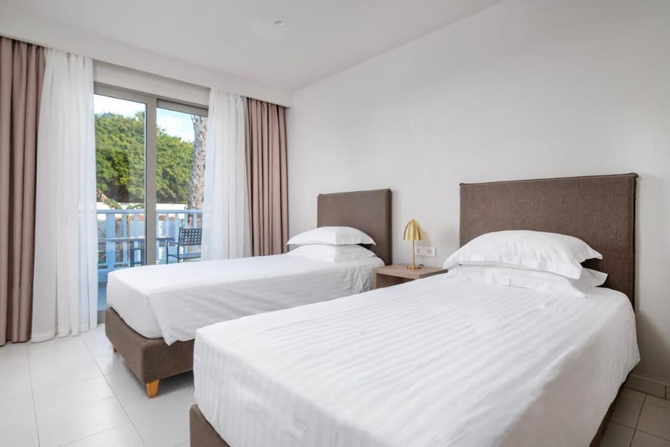 Standard Quadruple Room | Minibar, in-room safe, blackout drapes, iron/ironing board
