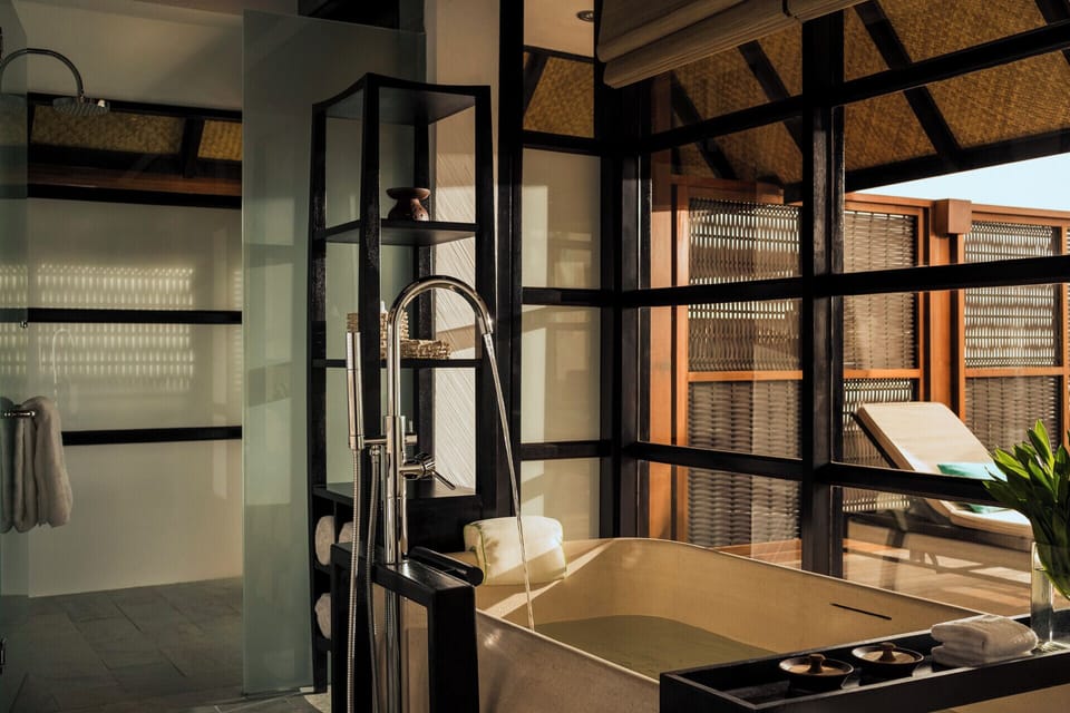 Combined shower/tub, designer toiletries, hair dryer, slippers