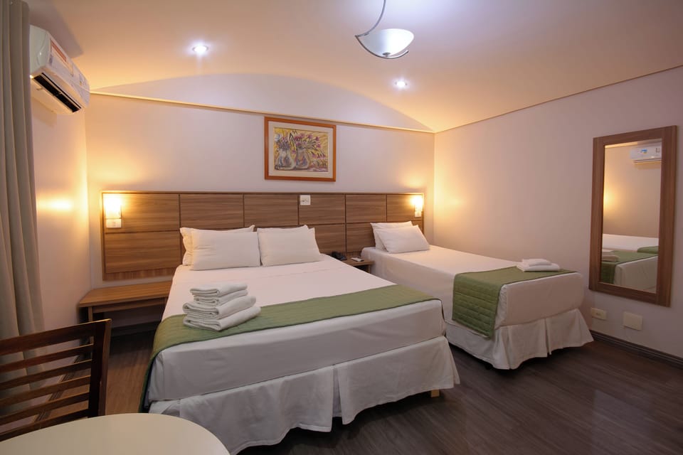 Family Triple Room | Minibar, blackout drapes, free WiFi, bed sheets