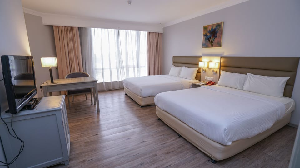 Deluxe Quadruple Room | Minibar, in-room safe, desk, soundproofing