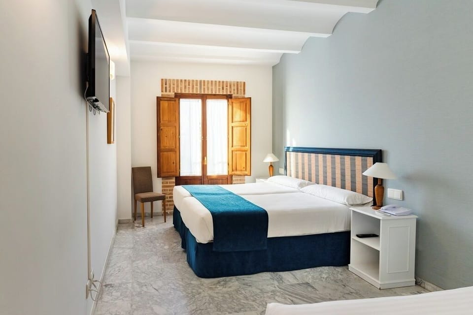 Triple Room | Minibar, in-room safe, desk, iron/ironing board